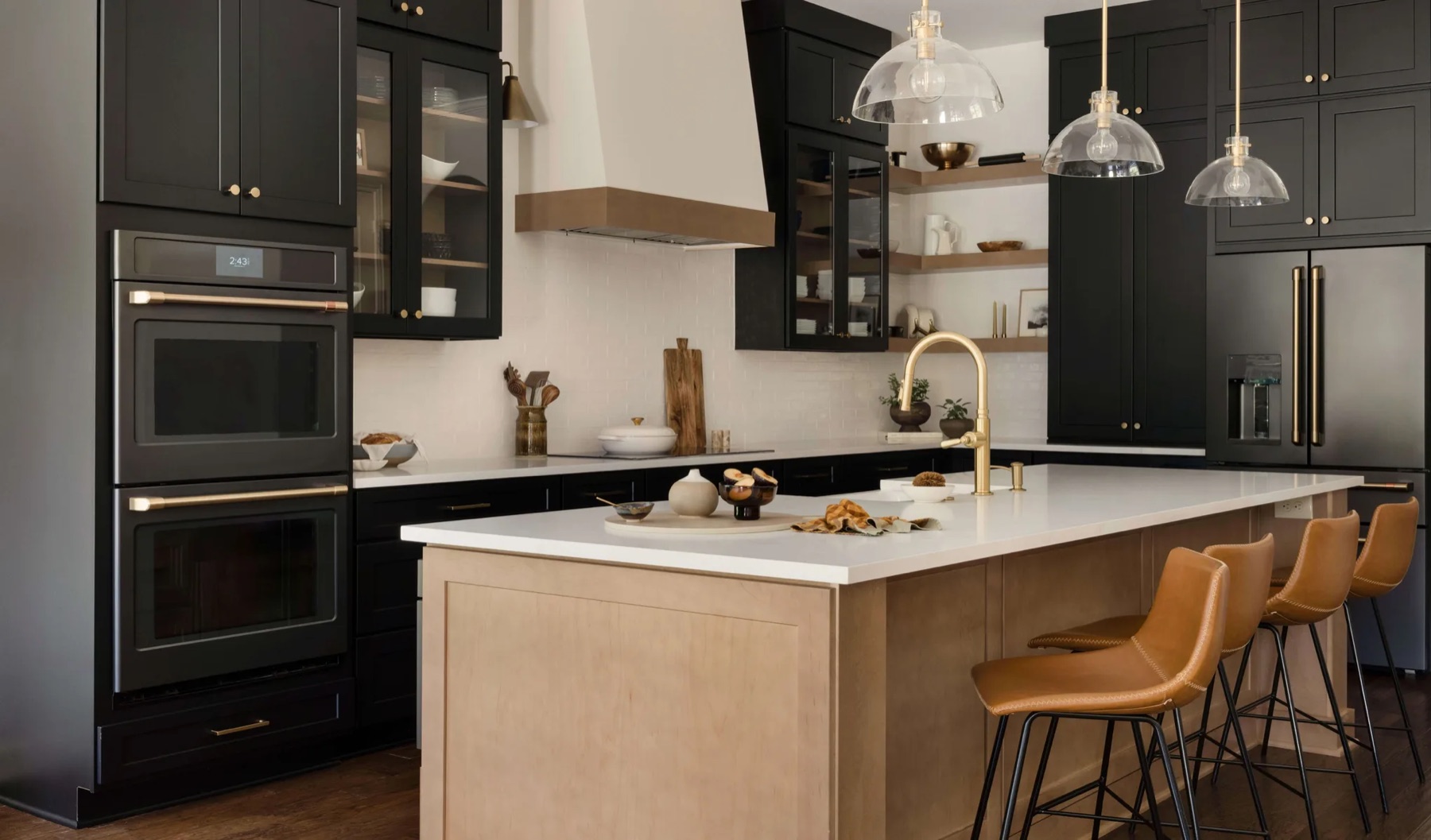 A finished Cabinet IQ kitchen with deep black cabinetry, white oak shelving, and crisp white countertops