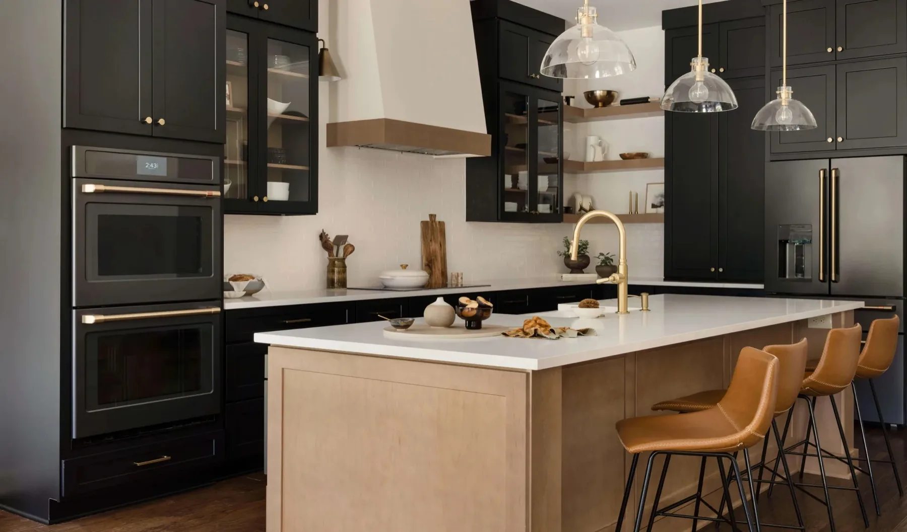 A finished Cabinet IQ kitchen with deep black cabinetry, white oak shelving, and crisp white countertops